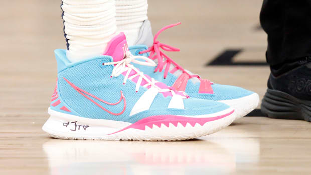 View of blue and pink Nike Kyrie shoes.
